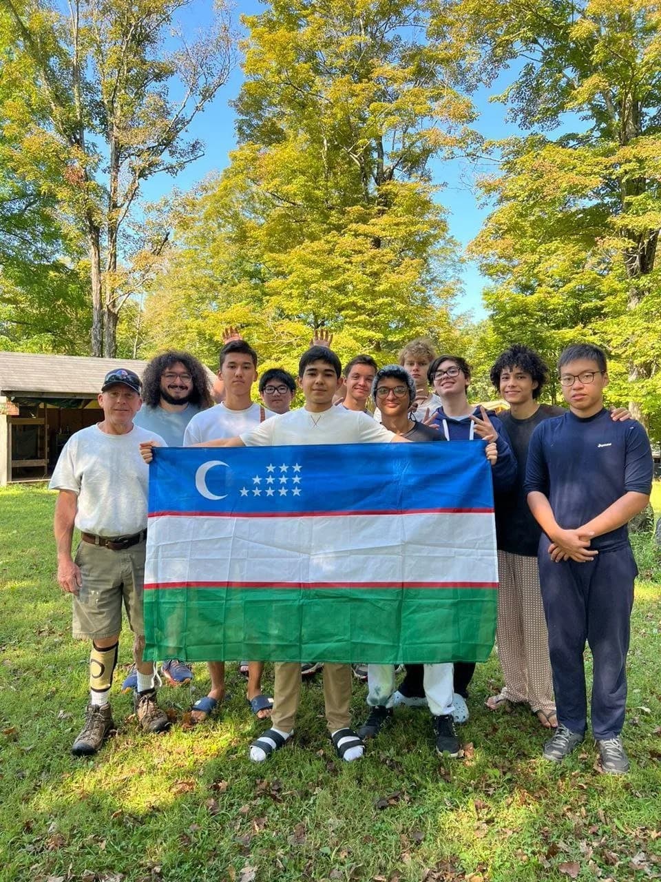 Campers from Camp Rising Sun holding the flag of Uzbekistan