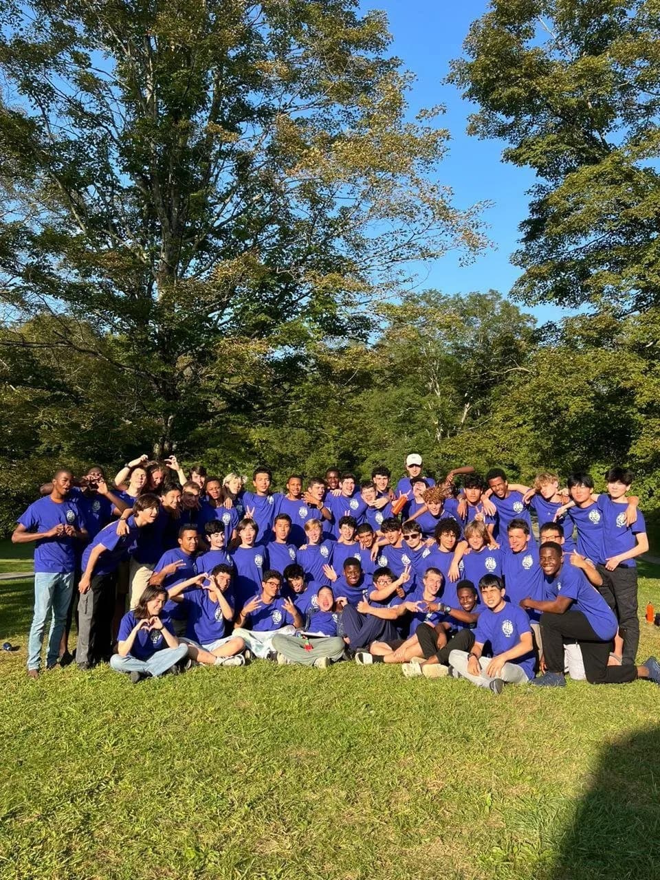The whole camp in matching shirts on the lawn